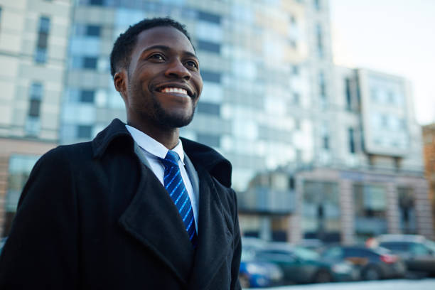 istock Successful African Businessman Smiling Outside Office Building 668256636