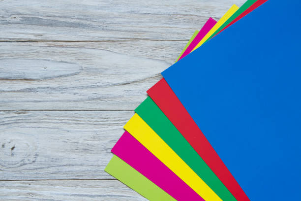 istock Color paper on wooden background corner 668267838