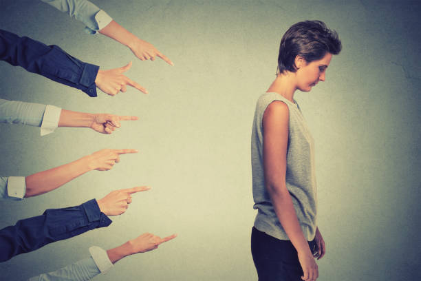 istock Side profile sad upset woman looking down many fingers pointing at her back 668268816