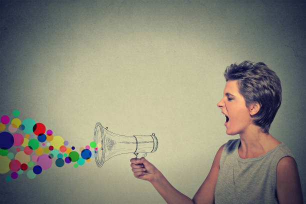 istock angry screaming young woman holding megaphone 668269514