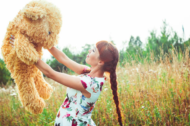 istock woman with a Teddy bear in nature 668270880