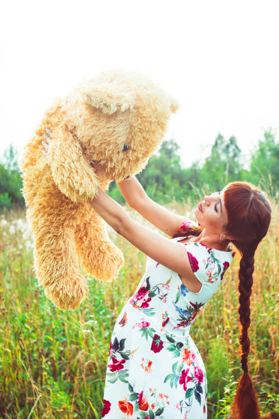 istock woman with a Teddy bear in nature 668271008