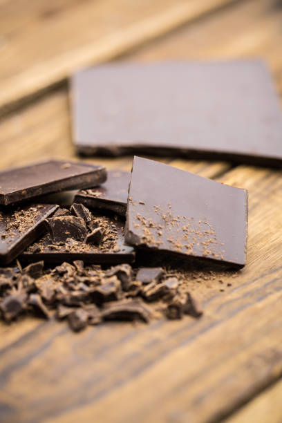 istock Pieces of chocolate on a wooden table 668271104