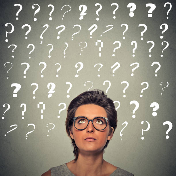 istock woman with puzzled face expression and question marks above her head looking up 668271464
