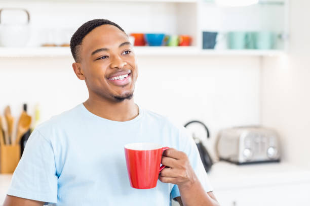 istock Happy man holding a cup of coffee 668271950