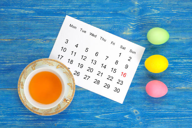 easter april 2017 calendar, colorful eggs on blue wooden table