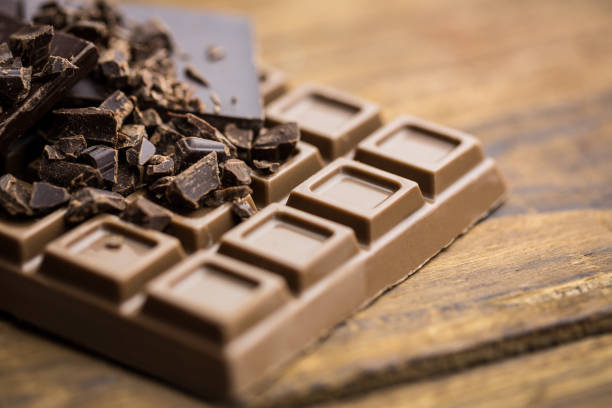 istock Dark and milk chocolate on a wooden table 668272226