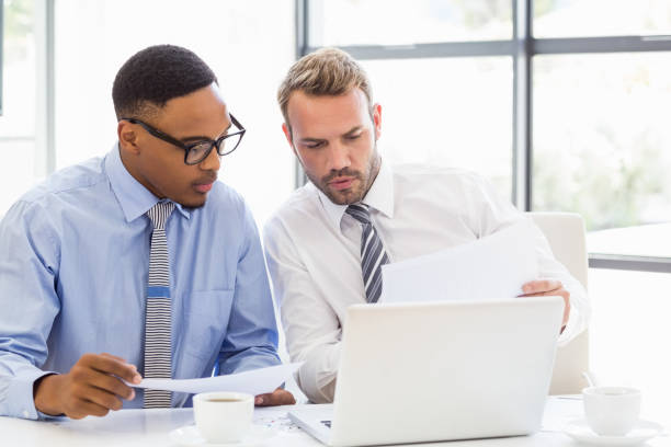 istock Businessmen discussing a report 668275904