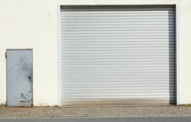 istock Garage door with pulled down shutters at an old factory shed 668281636