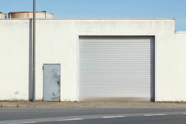 istock Garage door with pulled down shutters at an old factory shed 668281876