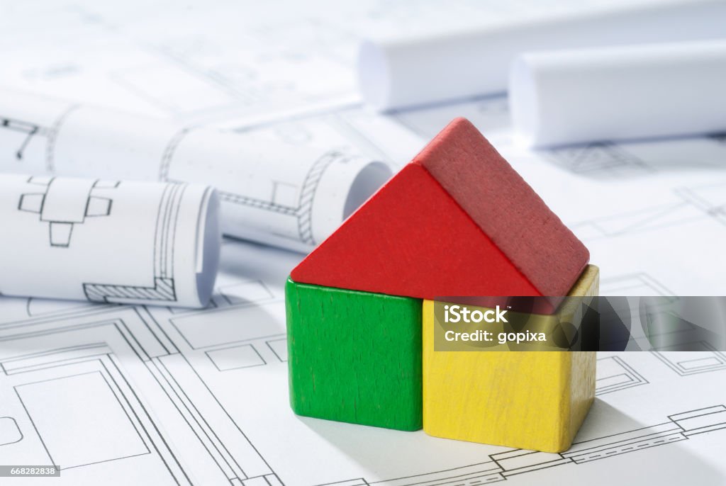 House made of building blocks on building plans House made of building blocks is written on building plans. House Stock Photo