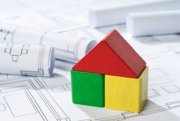 House made of building blocks on building plans House made of building blocks is written on building plans. zukunft stock pictures, royalty-free photos & images