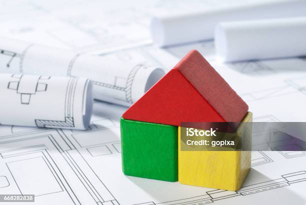 House Made Of Building Blocks On Building Plans Stock Photo - Download Image Now - House, Detached House, Toy Block