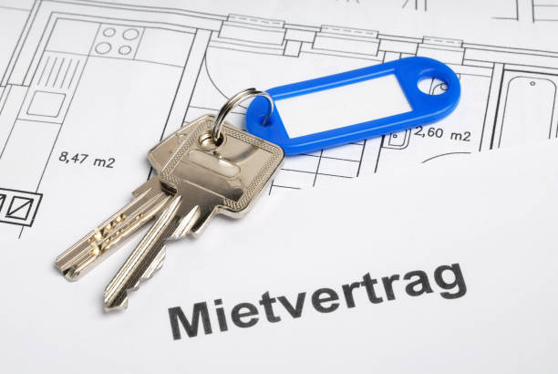 House key, rental contract and construction plan stock photo