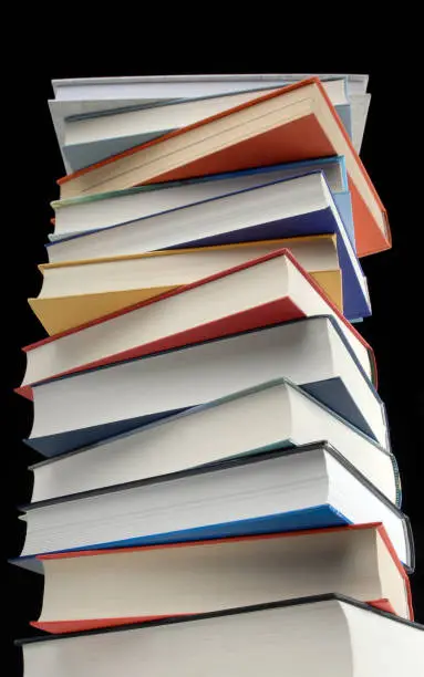 A stack of books against a black background