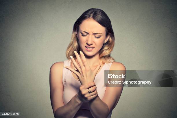 Young Woman Holding Her Painful Wrist Stock Photo - Download Image Now - Carpal Tunnel Syndrome, Women, Human Nervous System