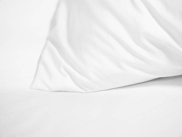 istock Closeup of white pillow on bed in bedroom. 668293382