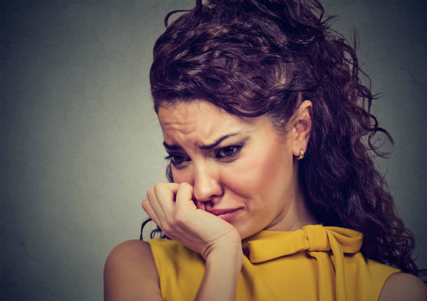 istock Closeup depressed sad woman leaning head on hand 668299902