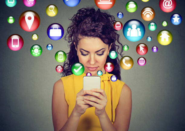istock Happy young woman using texting on smartphone with social media application symbols 668299910