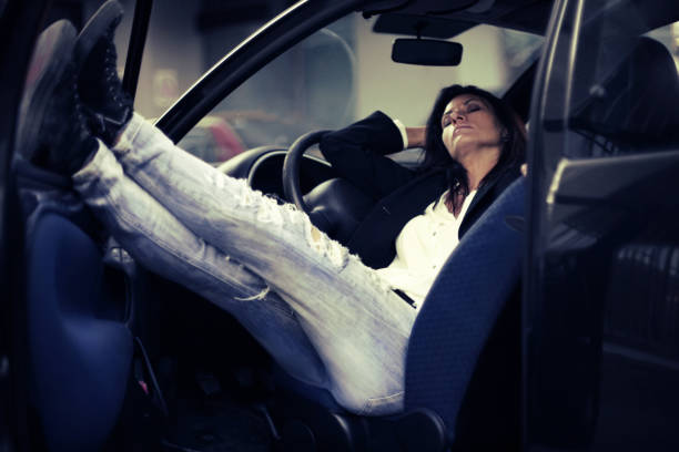 istock Young woman enjoying sitting in her car 668320026