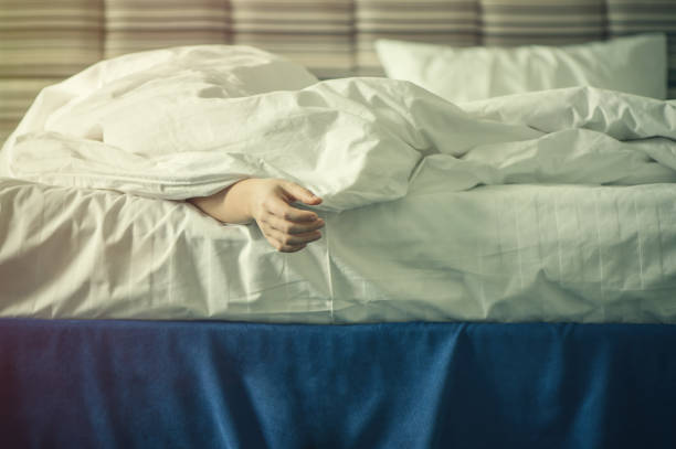istock Female hands under blanket at sunset. Sleeping girl 668325266