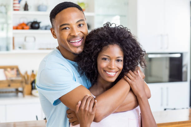 istock Young couple embracing in kitchen 668325772