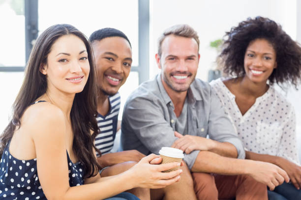 istock Friends sitting together on sofa 668326240