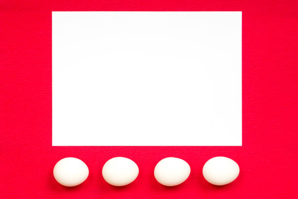 istock easter concept, white paper and eggs on red background 668326776