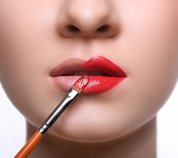 istock Make-up artist apply lipstick with brush, beauty 668336278