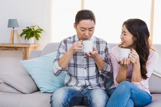 istock Happy woman looking at man while holding coffee cup 668337600