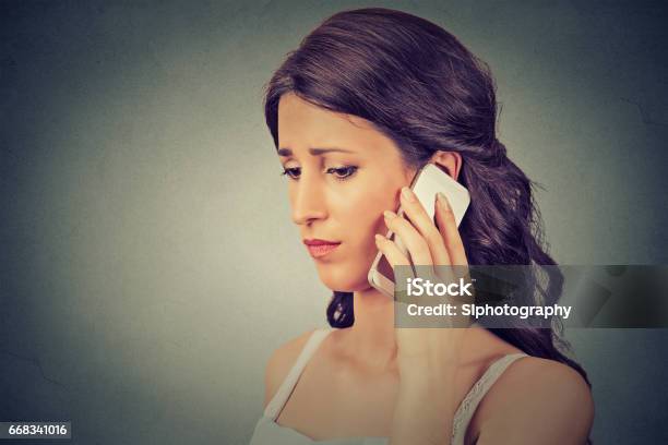 Concerned Young Woman Talking On Mobile Phone Stock Photo - Download Image Now - Adult, Adults Only, Arguing