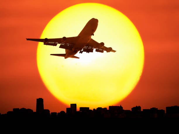 istock Airplane flying above city at dusk 668349312