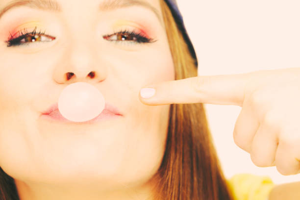 istock Funky girl making balloon. 668349972