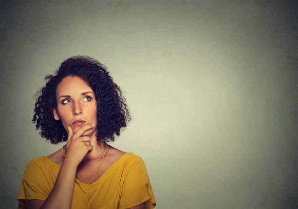 istock Woman thinking dreaming has many ideas looking up 668354472