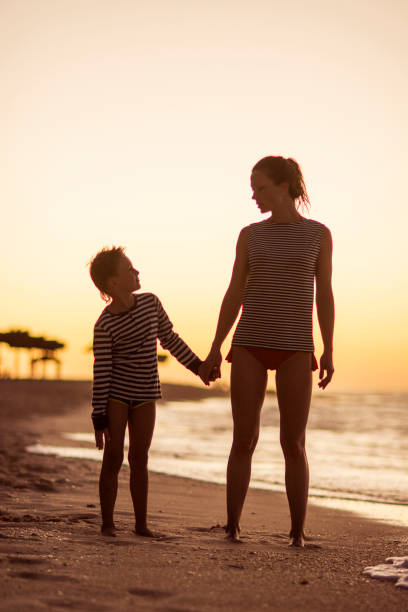 istock Mother and her son holding hands 668361220