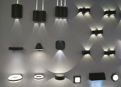 Many outdoor and indoor electric lamps mounted on the wall of the store