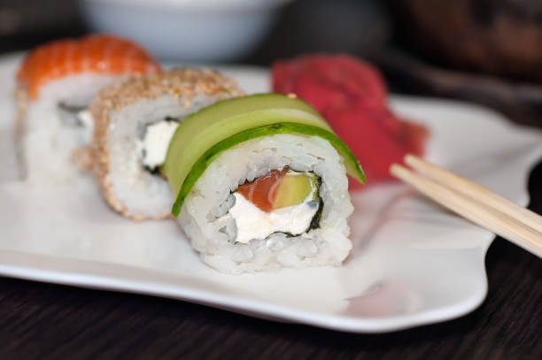 istock Sushi rolls with red fish, cucumber and philadelphia cheese 668367966