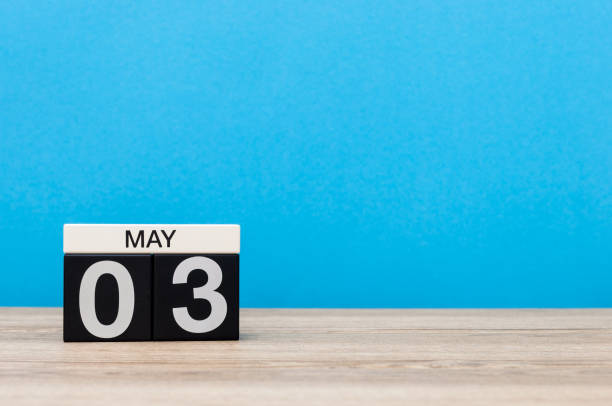 istock May 3rd. Day 3 of month, calendar on blue background. Spring time, empty space for text 668368302