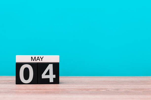 istock May 4th. Day 4 of month, calendar on turquoise background. Spring time, empty space for text 668370754