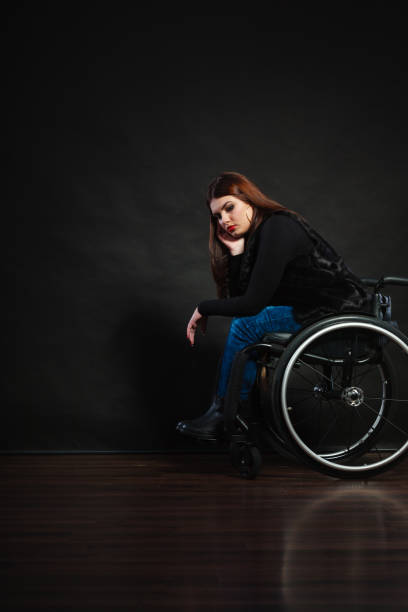 istock Sad girl sitting on wheelchair. 668371102