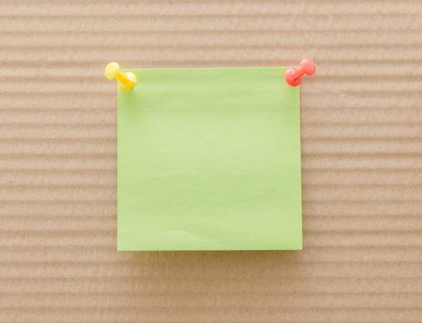 blank reminder note nailed to a wooden plank or wall