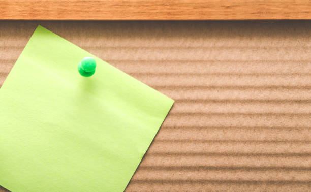 blank reminder note nailed to a wooden plank or wall