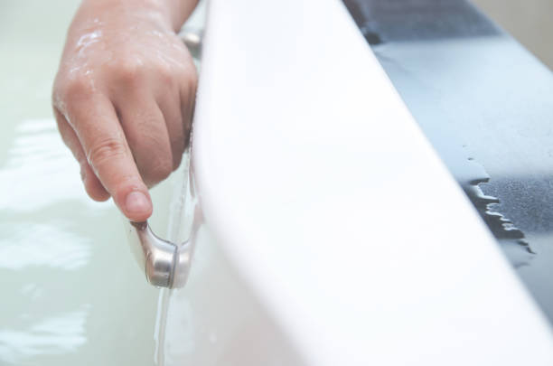 istock Closeup on hand laying in bathtub 668378886