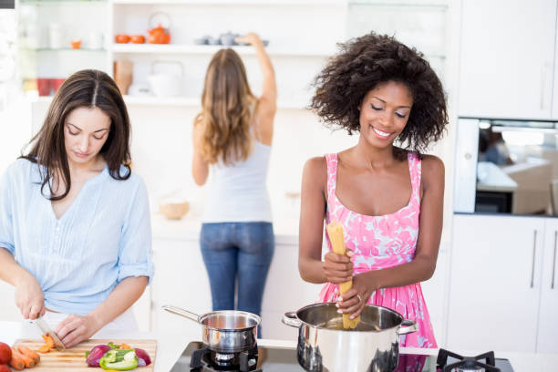 istock Friends preparing a meal in kitchen 668385294