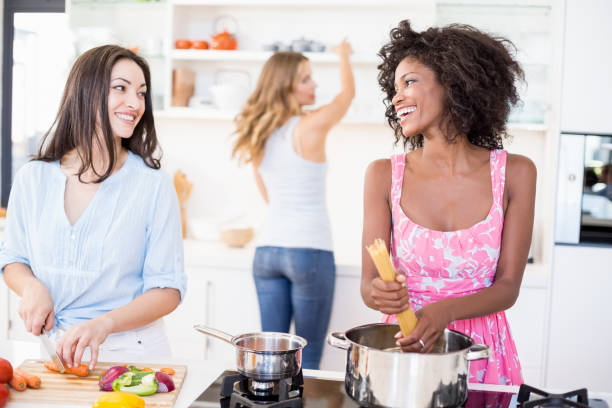 istock Friends preparing a meal in kitchen 668385368