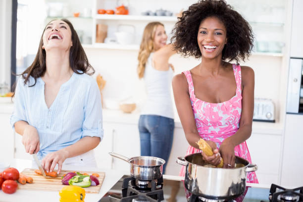 istock Friends preparing a meal in kitchen 668385394