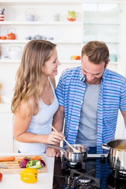 istock Young couple preparing a meal in kitchen 668385722