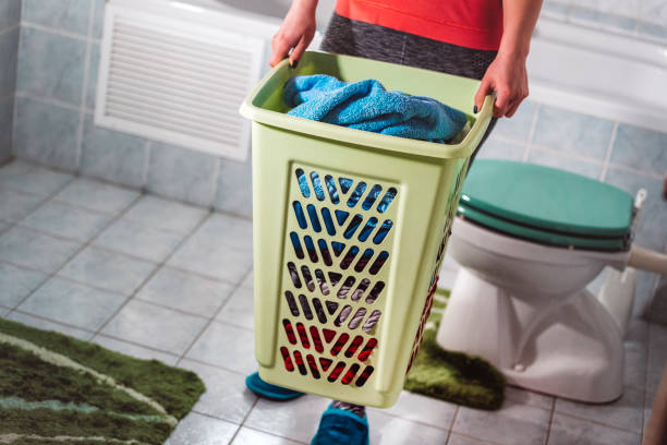 istock Young woman holding full laundry basket 668388842