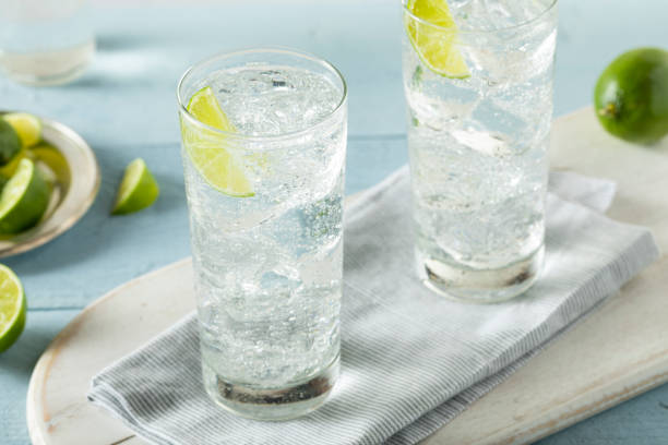 Refreshing Hard Sparkling Water Refreshing Hard Sparkling Water with a Lime Garnish tonic water stock pictures, royalty-free photos & images