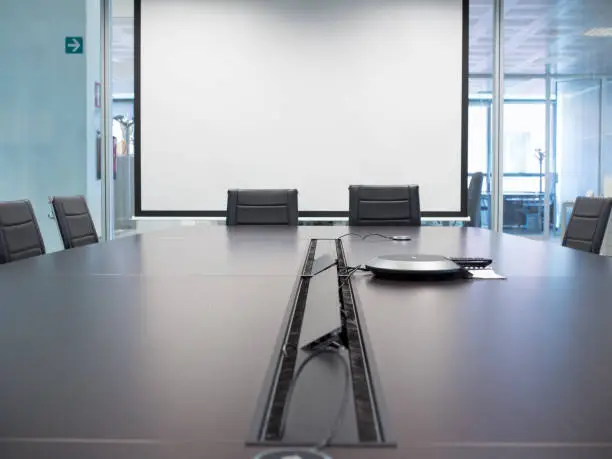 wheelchairs in a conference room with projection screen